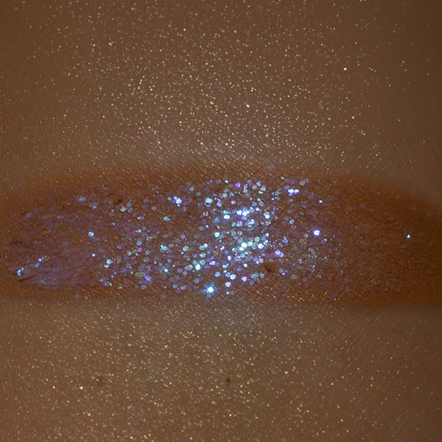 Close-up of a dull glitter swatch on skin without forplay setting mist